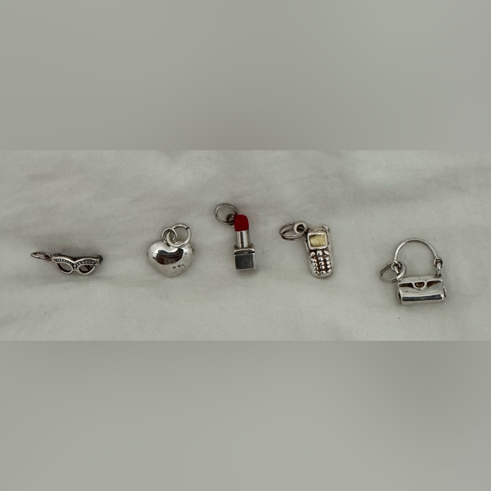 Sterling silver.  5 charms.